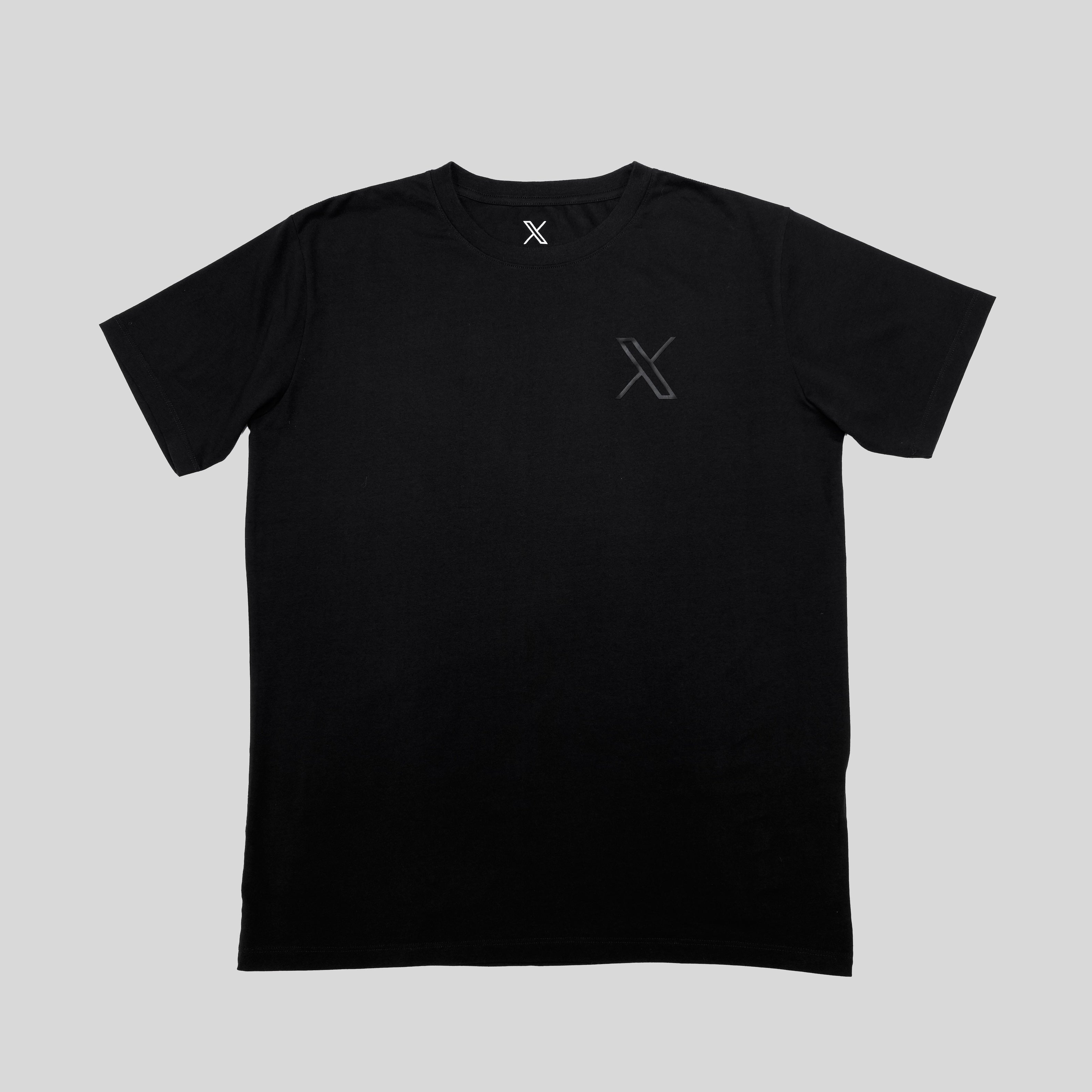 An image of the Unisex 3D Logo Tee showing a flat laid black t-shirt with a black X logo on the top left.